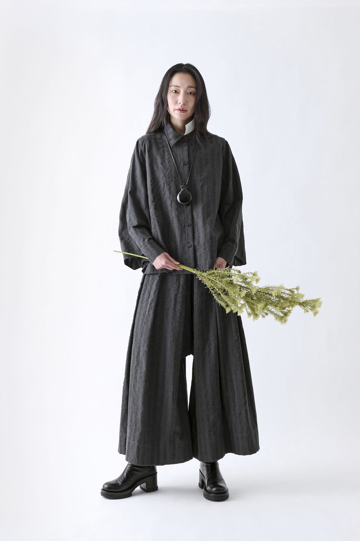 Soh front styling view of black and grey check shirt with matching wide trousers