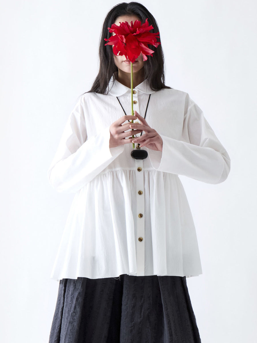 Soh front view of white gathered shirt with rounded collar and button front