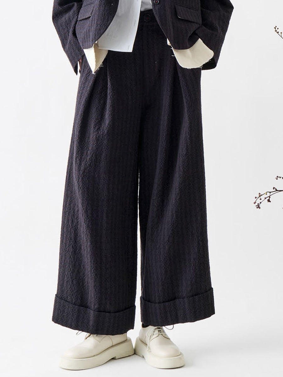 Soh front detail of brown and navy check trousers with deep turn-ups