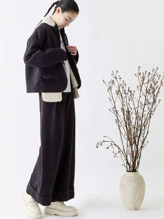 Soh side styling view of check trousers with matching jacket