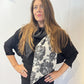 Igor Dobranic Imortelle grey floral scarf draped around the neck with its contrasting charcoal section