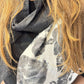 Close-up of the Imortelle scarf showing the fine fabric texture and grey floral design