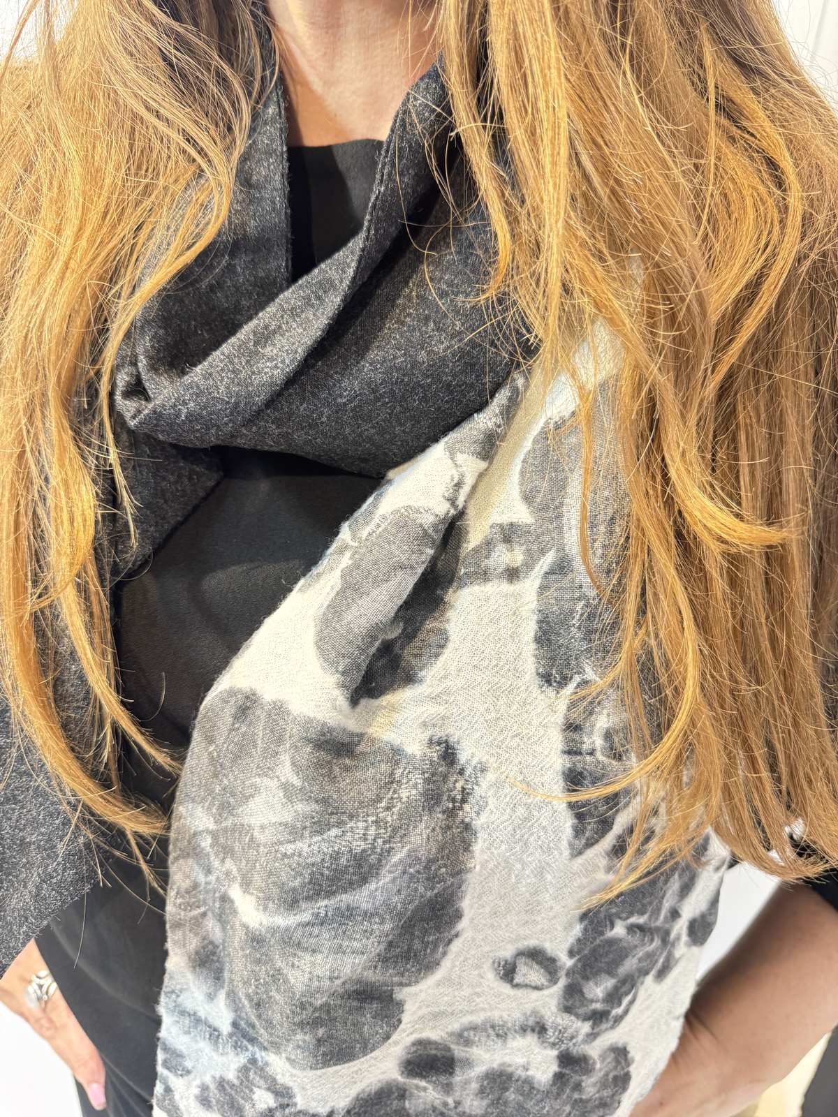 Close-up of the Imortelle scarf showing the fine fabric texture and grey floral design