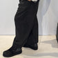 Side view of the Ivy trousers showing their sculptural shape and ankle-length hem
