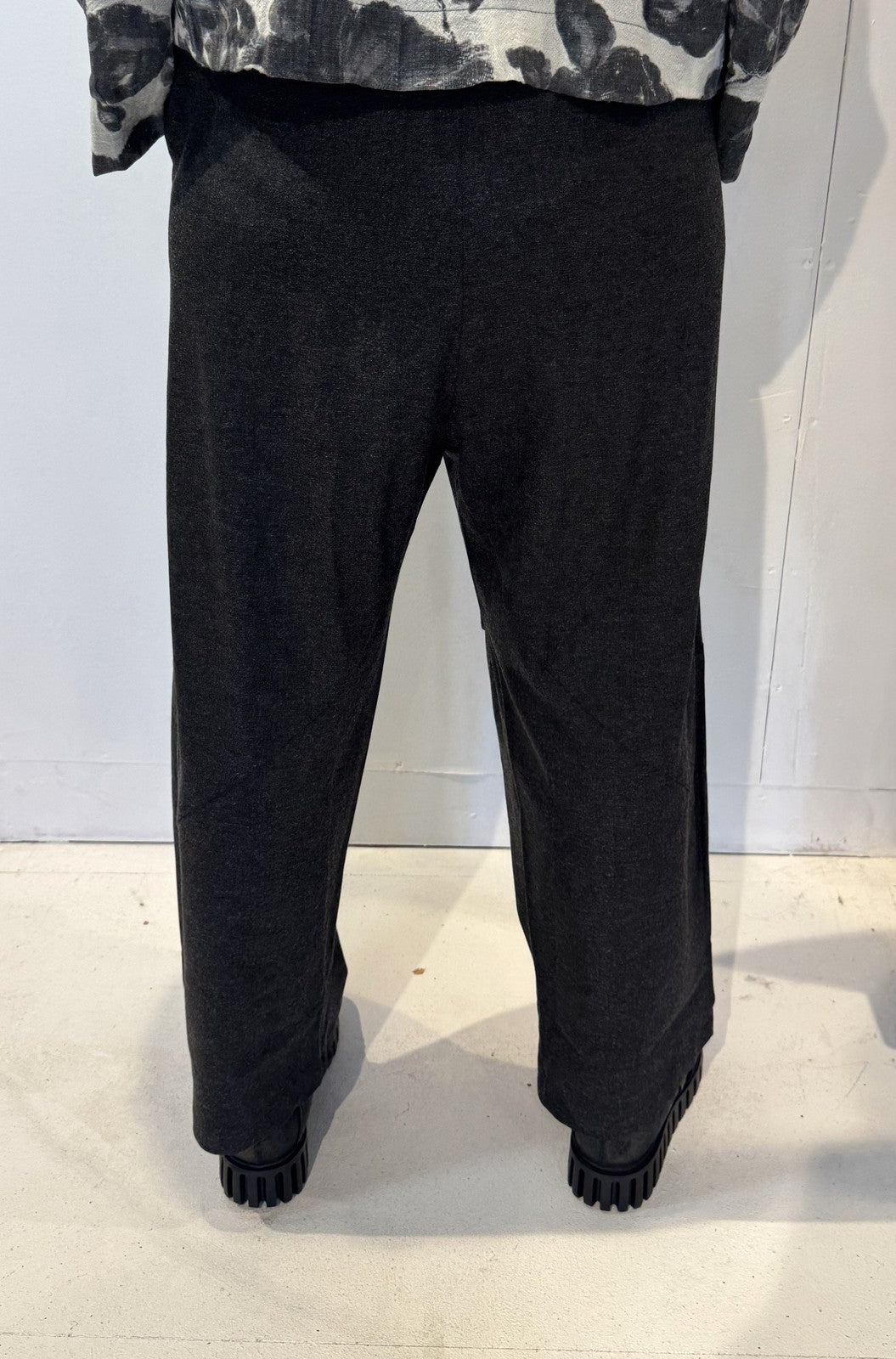 Back view of the Ivy dark grey trousers showing their tapered legs