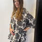 Side view of the Lantana tunic showing the elbow-length sleeve and curved hem