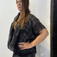 Side view of the Lotus waistcoat showing its extended shoulder and short silhouette