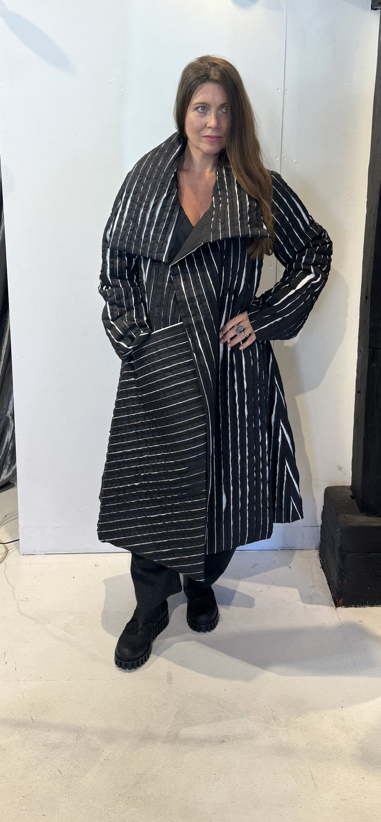 Igor Dobranic Magnolia black and white coat worn open, showing its broad lapels and contrasting stripe directions