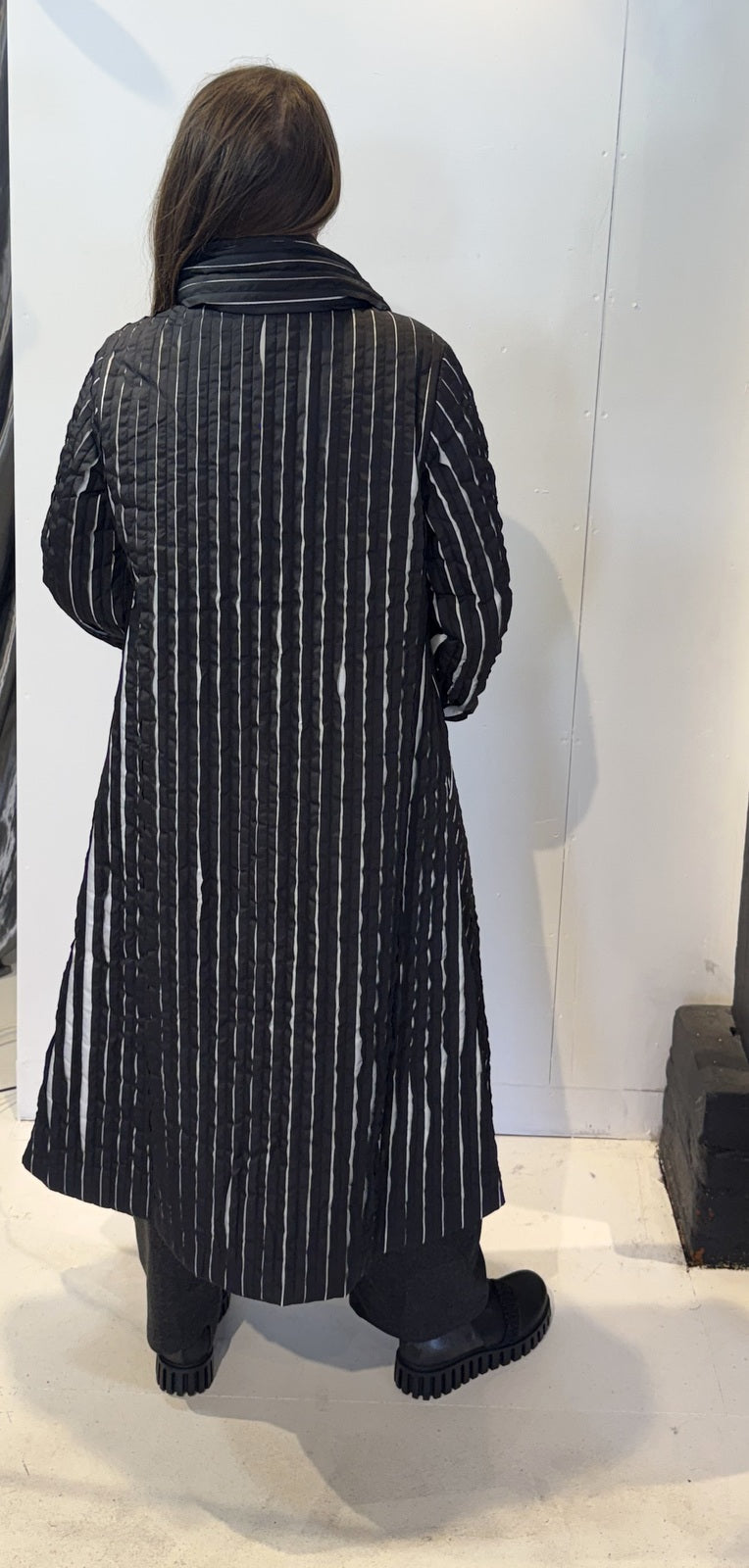 Back view of the Magnolia coat showing vertical white stripes and a gently flared hem