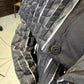 Close-up of the Magnolia coat showing its covered button and raised striped texture