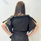 Back view of the May bolero showing its short body and broad shoulder folds
