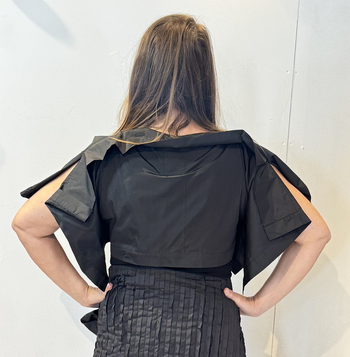 Back view of the May bolero showing its short body and broad shoulder folds