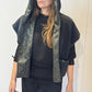 Front view of the Pensy waistcoat on its plain black side with the hood raised