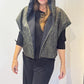 Front view of the Pensy waistcoat with its green patterned side outward and hood raised