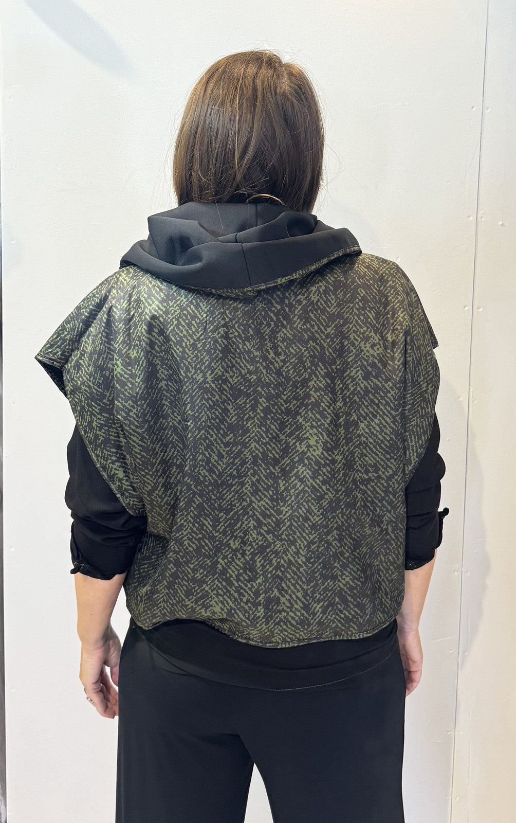 Back view of the Pensy waistcoat showing its green pattern with the hood down
