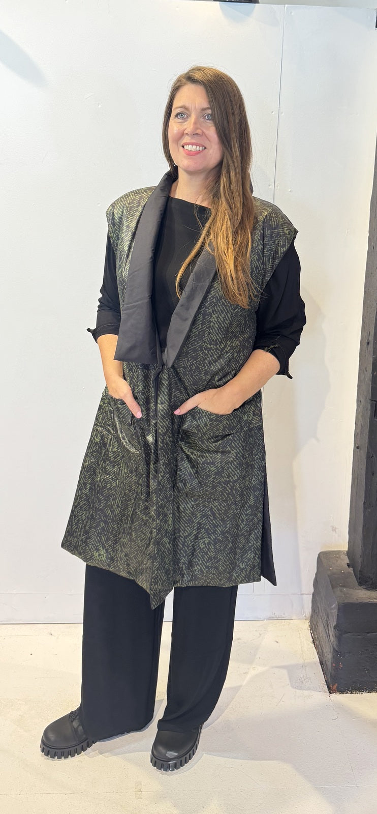 Front view of the Igor Dobranic Rue waistcoat showing its black and green pattern and black lapels