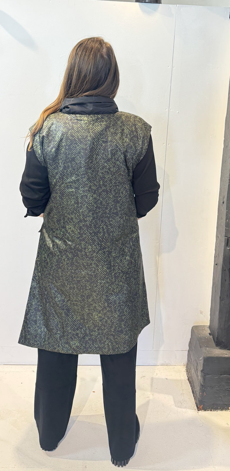 Back view of the Rue waistcoat showing the abstract green pattern and extended shoulders