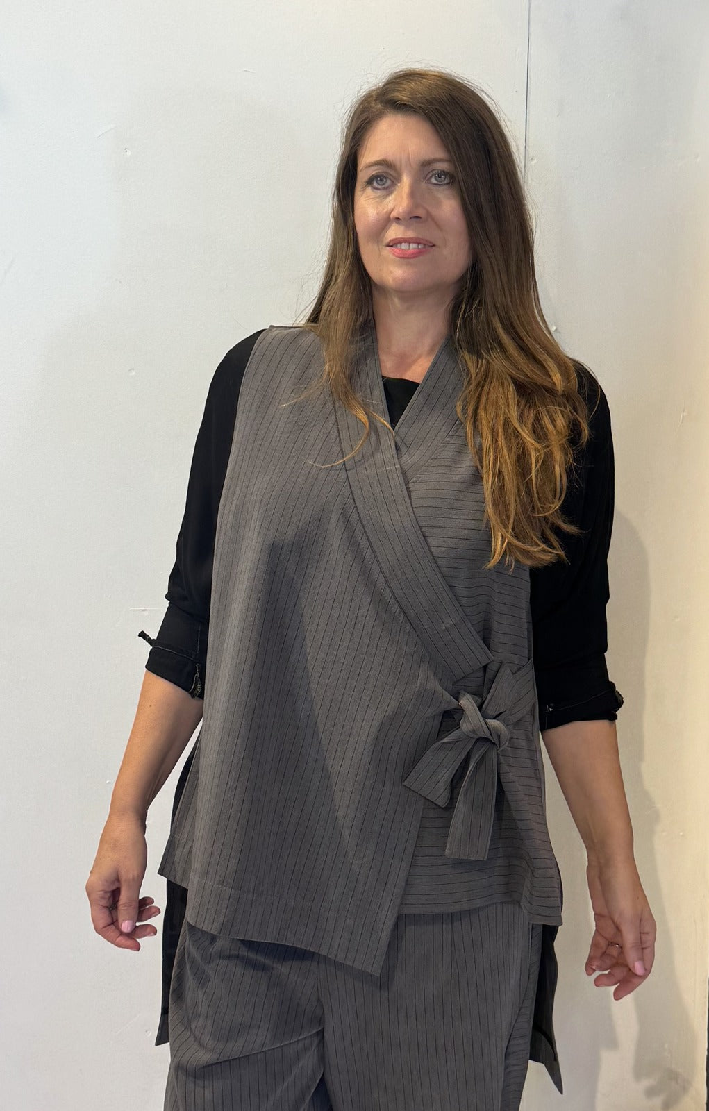 Front view of the Igor Dobranic Senna grey pinstriped waistcoat showing its overlapping front and side tie