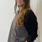 Side view of the Senna waistcoat showing its fabric tie and longer back