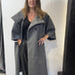 Igor Dobranic Sorrel grey coat worn open, showing wide lapels and curved patch pockets