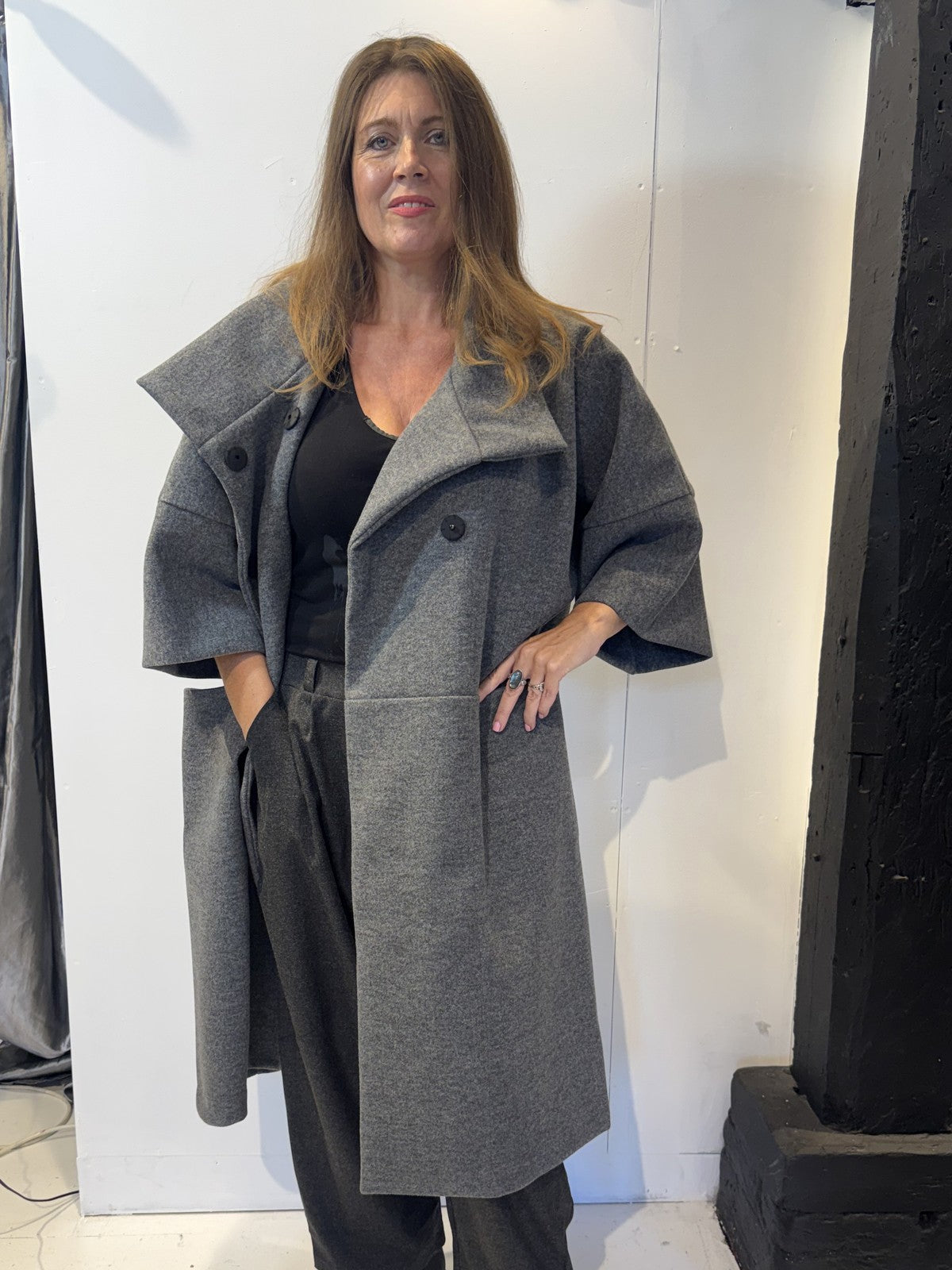 Igor Dobranic Sorrel grey coat worn open, showing wide lapels and curved patch pockets