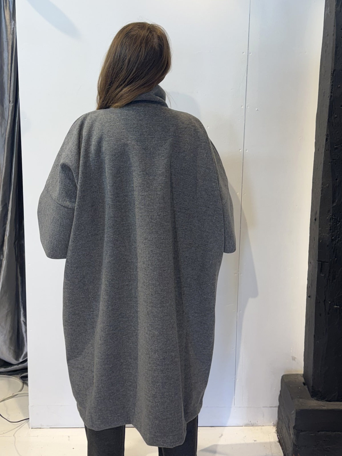 Back view of the Sorrel grey coat showing its sculptural silhouette