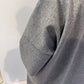 Close-up of the Sorrel coat showing its curved patch pocket and mottled grey texture