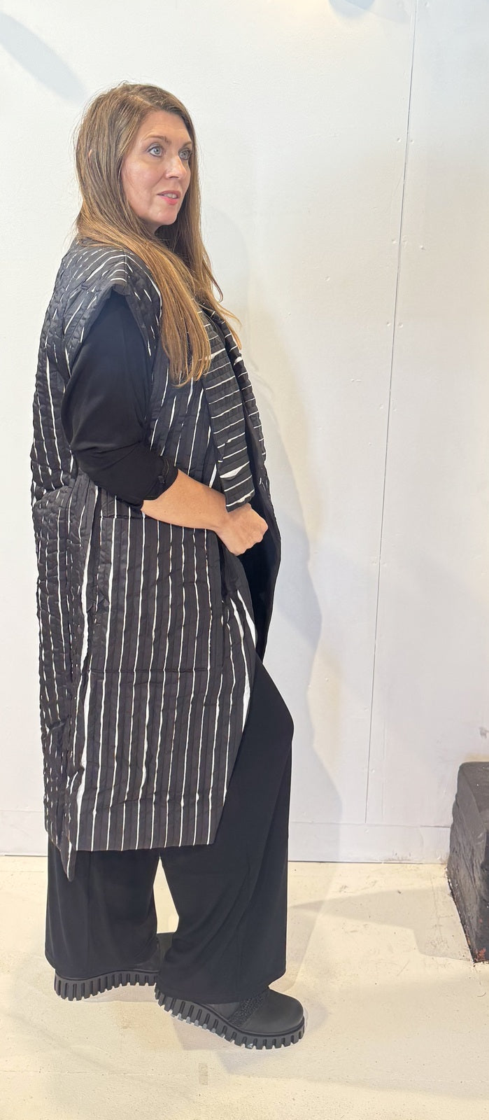 Side view of the Tulip waistcoat showing its side pocket and long striped silhouette