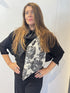 Igor Dobranic Imortelle grey floral scarf draped around the neck with its contrasting charcoal section