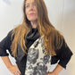 Closer view of the Imortelle scarf showing its floral panel and angled end