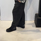 Side view of the Ivy trousers showing their sculptural shape and ankle-length hem