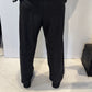 Back view of the Ivy dark grey trousers showing their tapered legs