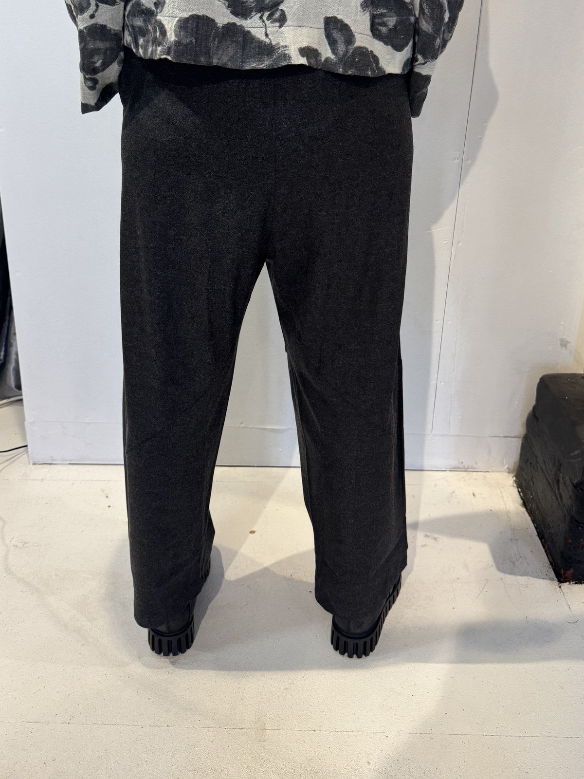 Back view of the Ivy dark grey trousers showing their tapered legs