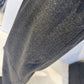 Close-up of the Ivy trousers showing the fine mottled grey fabric