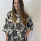 Front view of the Igor Dobranic Lantana grey floral tunic with an uneven hem