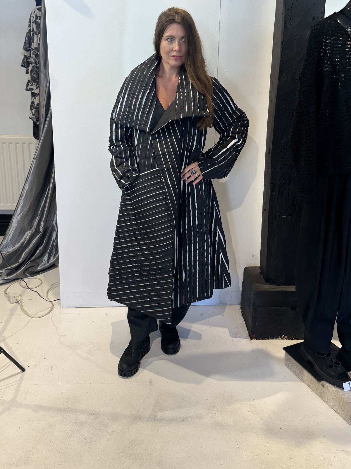 Igor Dobranic Magnolia black and white coat worn open, showing its broad lapels and contrasting stripe directions