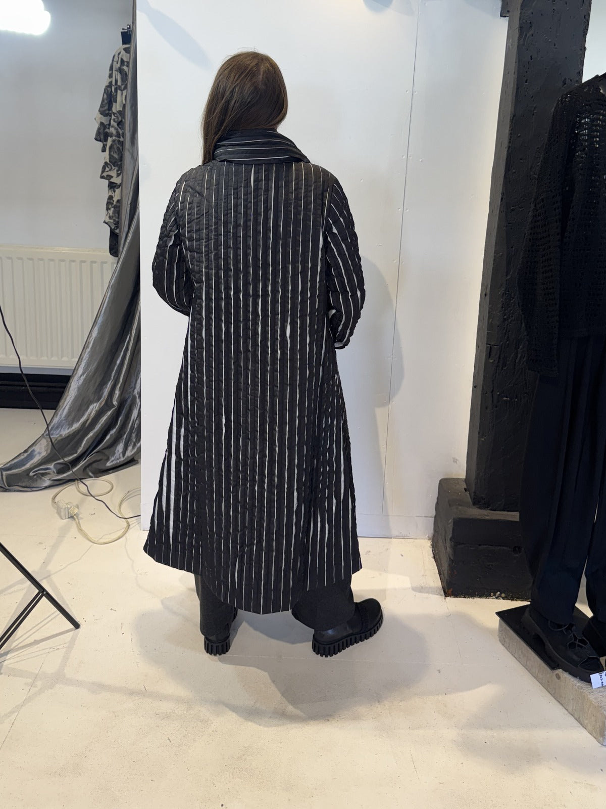 Back view of the Magnolia coat showing vertical white stripes and a gently flared hem