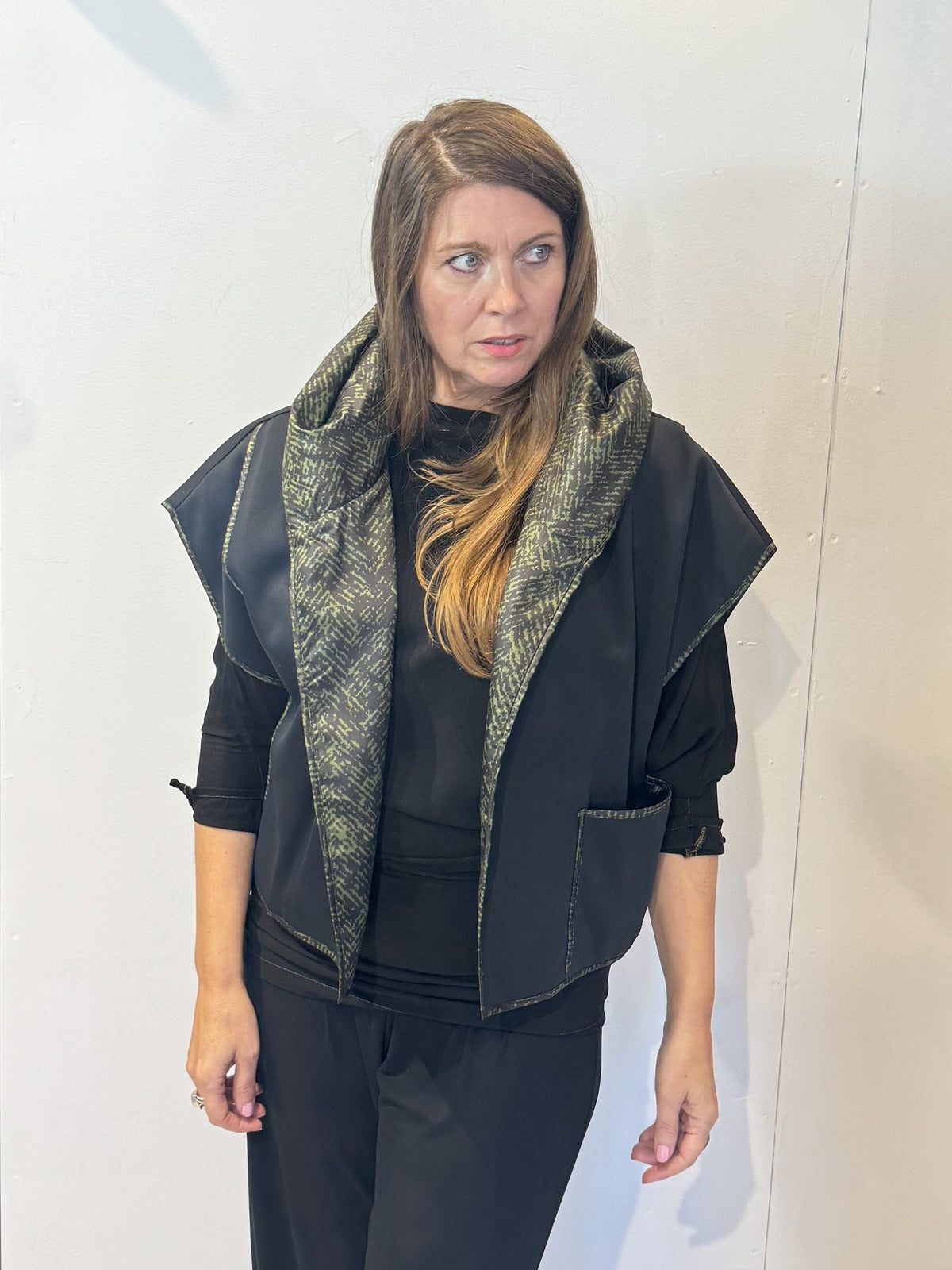 Front view of the Igor Dobranic Pensy reversible waistcoat showing the plain black side and green patterned collar