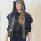 Front view of the Pensy waistcoat on its plain black side with the hood raised