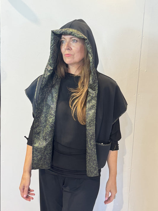 Front view of the Pensy waistcoat on its plain black side with the hood raised