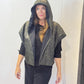 Front view of the Pensy waistcoat with its green patterned side outward and hood raised