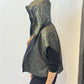 Side view of the Pensy waistcoat showing its patterned side and raised hood