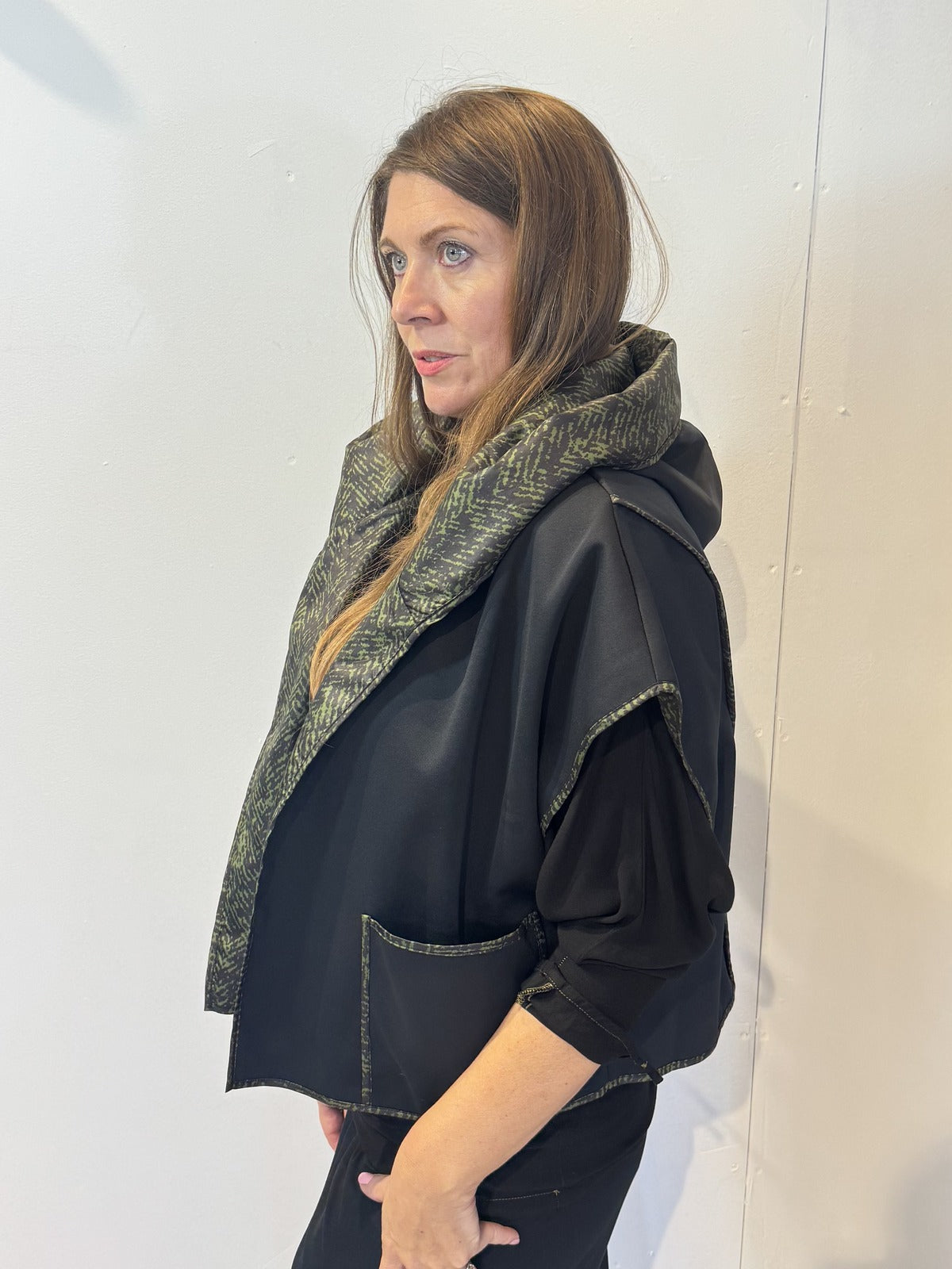 Side view of the Pensy waistcoat showing its plain black side and patch pocket