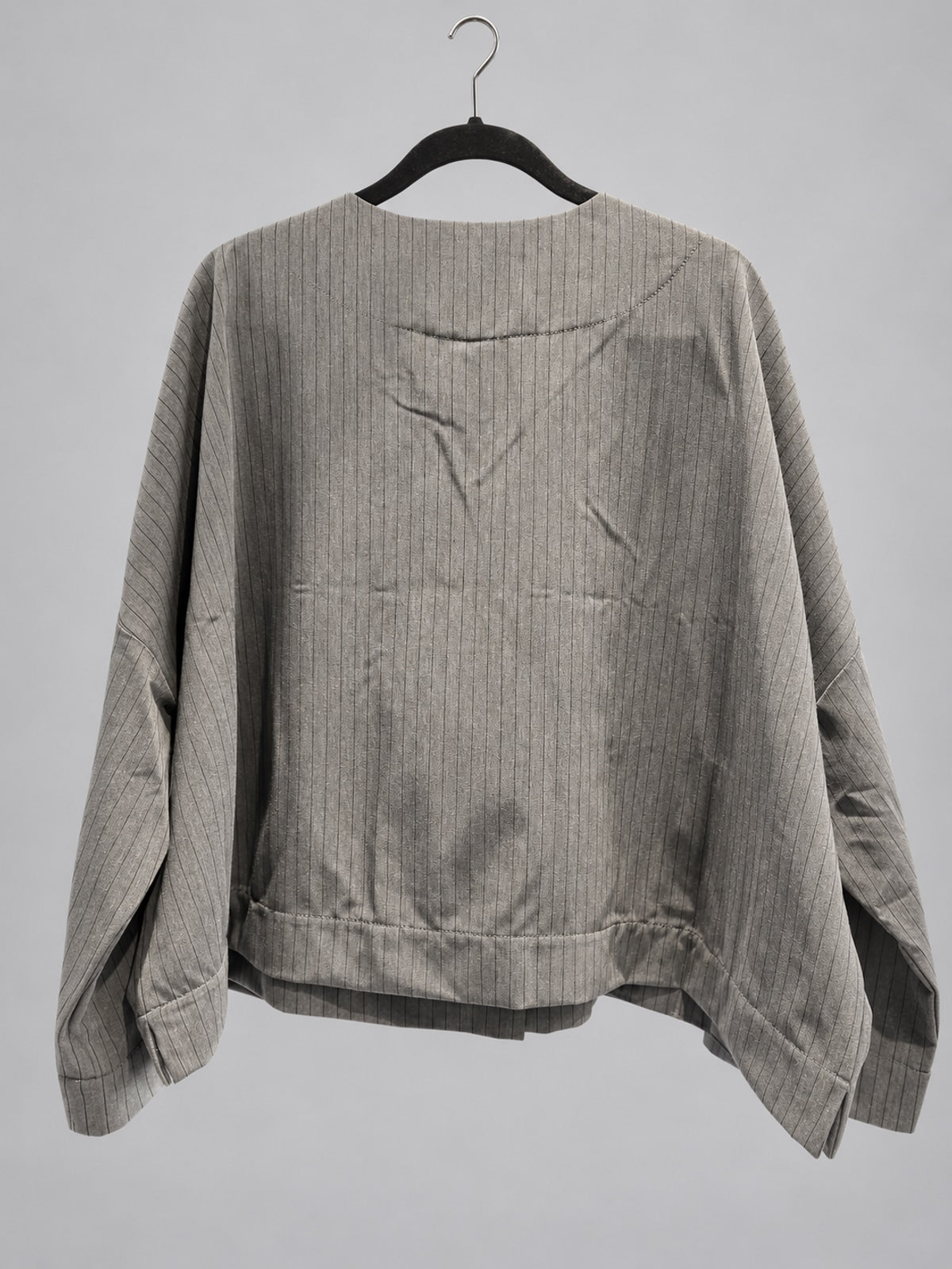 Back view of Igor Dobranic Petunia grey pinstriped jacket showing dropped shoulders and broad hem