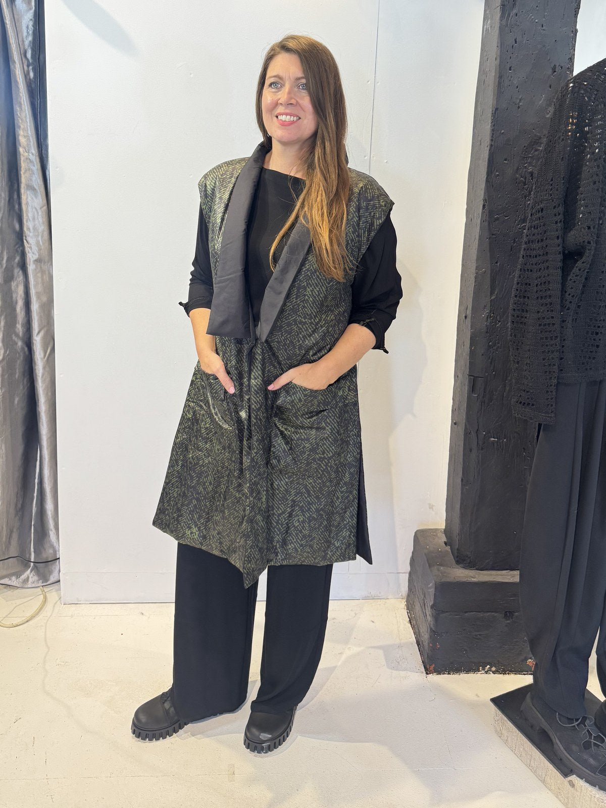 Front view of the Igor Dobranic Rue waistcoat showing its black and green pattern and black lapels