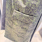 Close-up of the Rue waistcoat showing the patterned patch pocket and lightly lustrous fabric