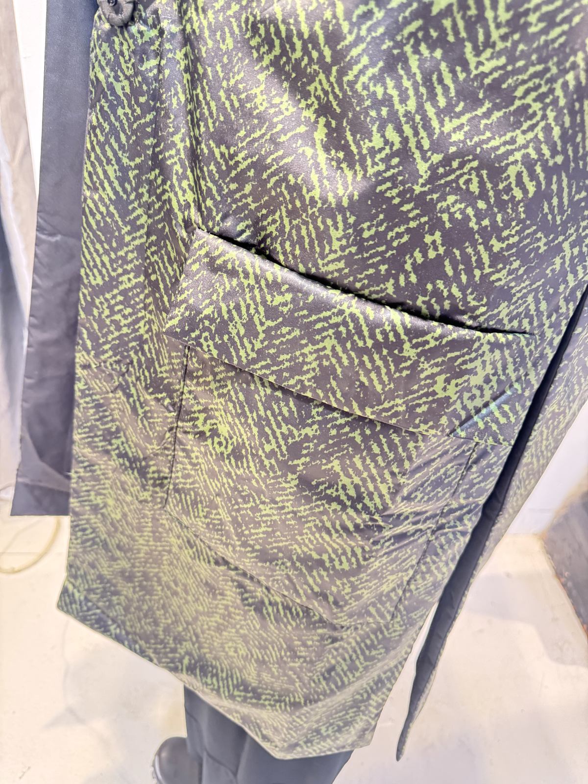 Close-up of the Rue waistcoat showing the patterned patch pocket and lightly lustrous fabric
