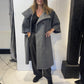 Igor Dobranic Sorrel grey coat worn open, showing wide lapels and curved patch pockets