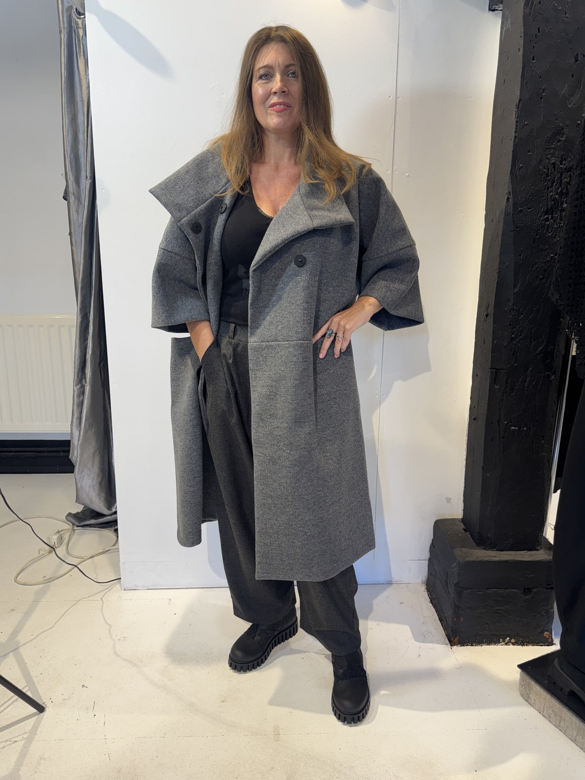 Igor Dobranic Sorrel grey coat worn open, showing wide lapels and curved patch pockets