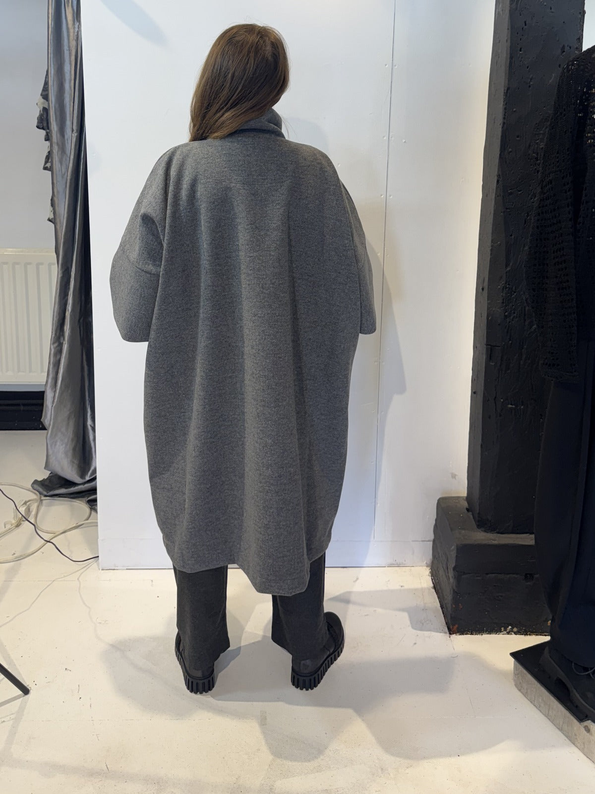 Back view of the Sorrel grey coat showing its sculptural silhouette